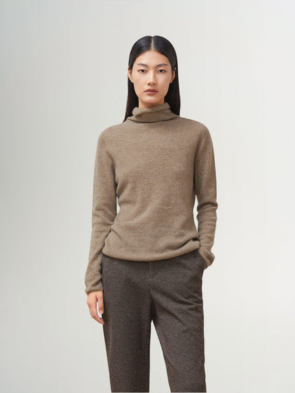 A woman wearing a women's premium brown turtleneck cashmere sweater with a classic fit, showcasing a luxurious and cozy look