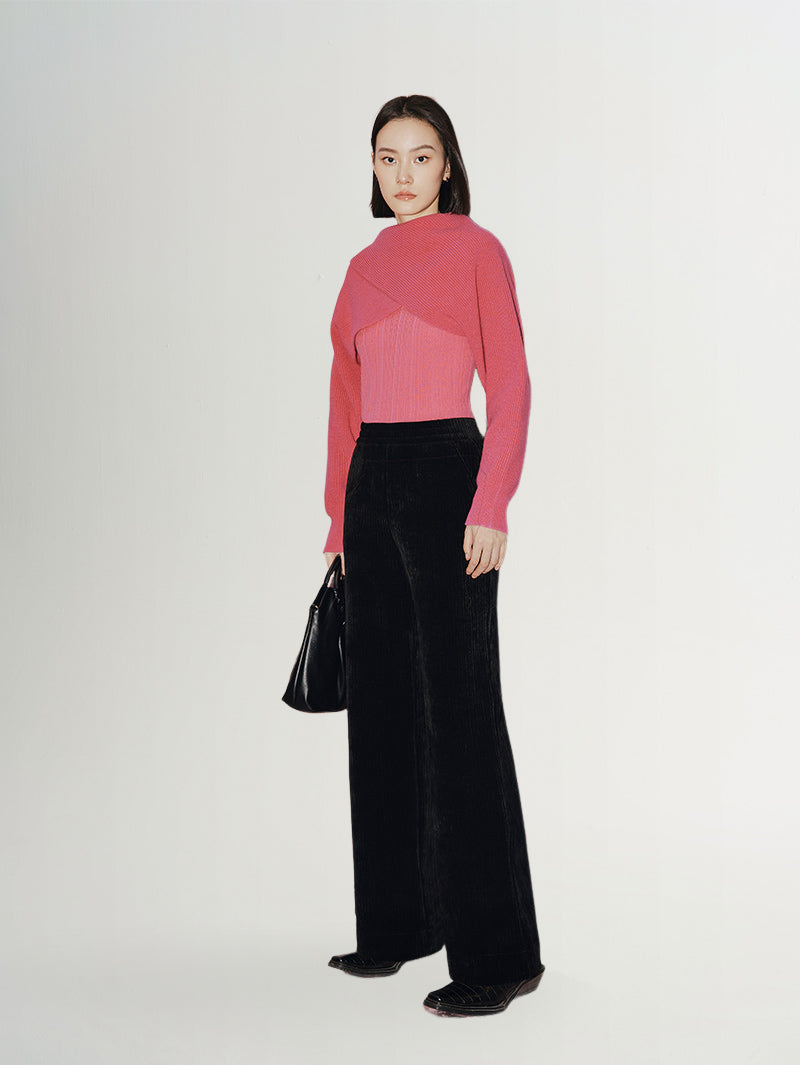 Model wearing Wide Leg Trousers paired with a pink sweater and black handbag, showcasing a stylish casual look.