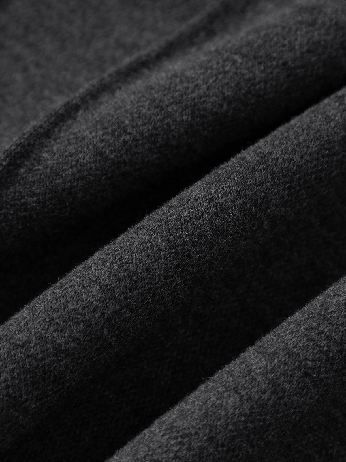 Close-up of dark gray fabric with a textured surface