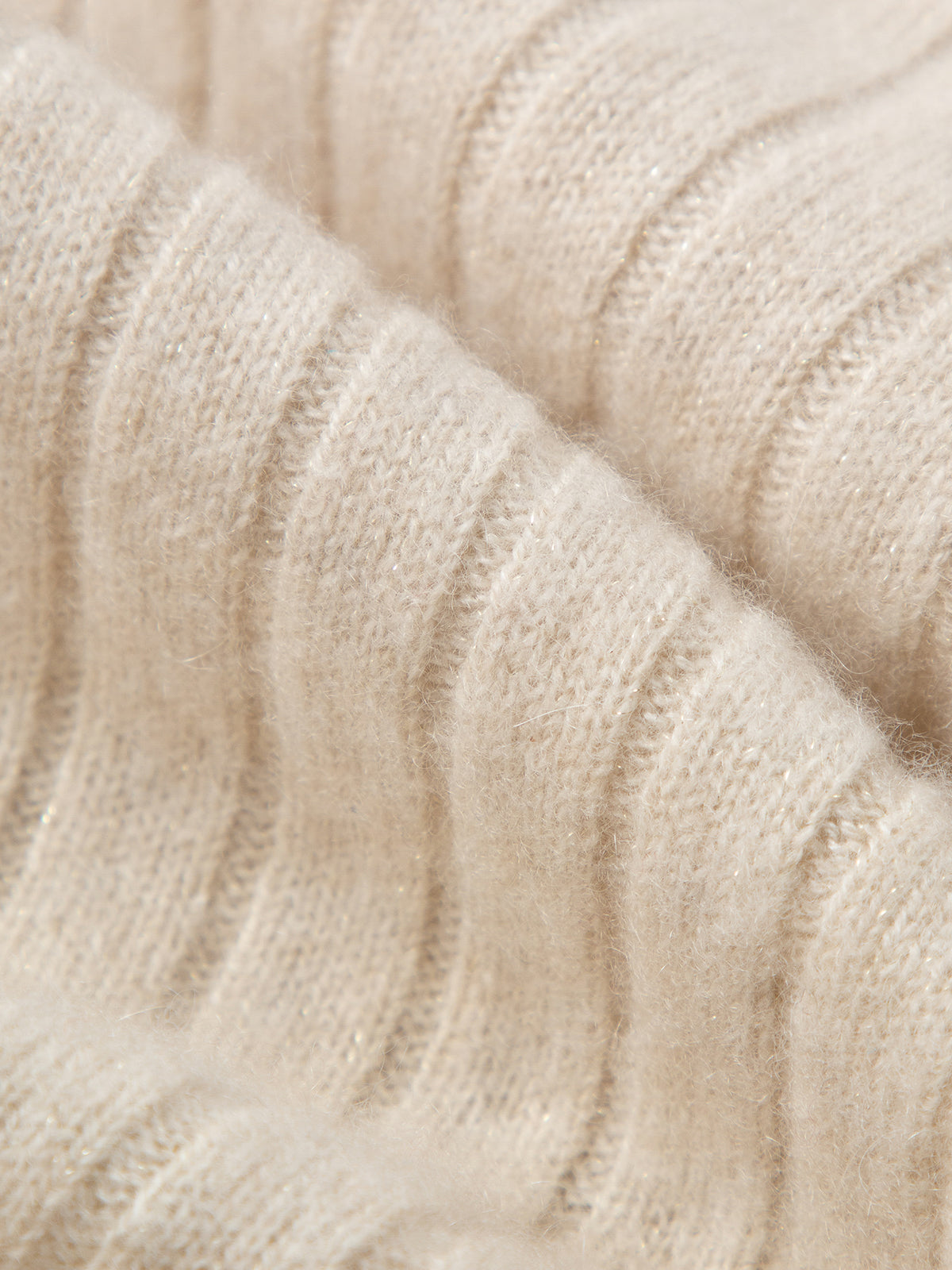 Close-up of beige knitted fabric texture