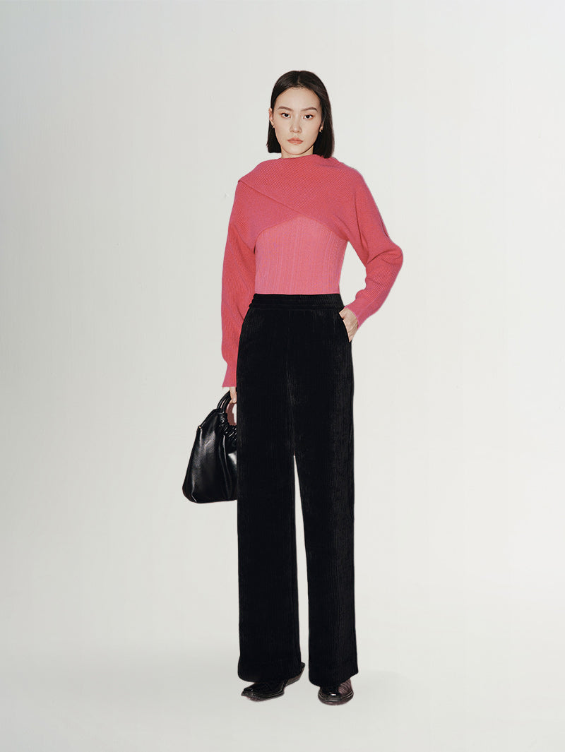 Model wearing Wide Leg Trousers styled with a pink top and black handbag, showcasing a luxe and casual outfit.