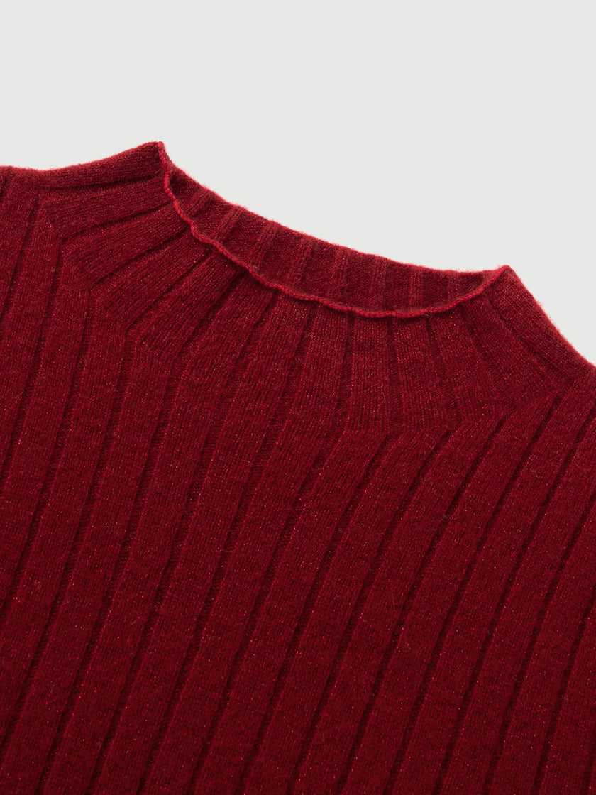 Close-up of a red ribbed sweater collar on a light gray background
