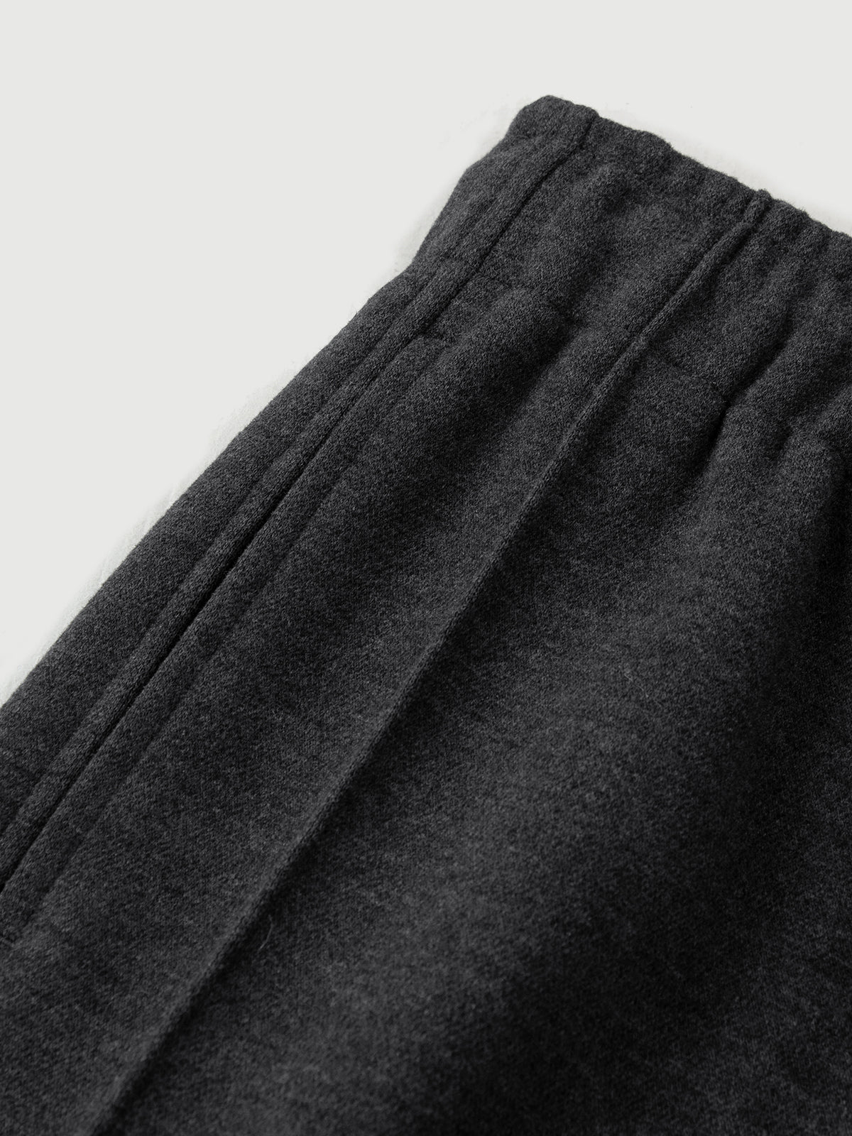 Dark gray sweatpants on a light gray background