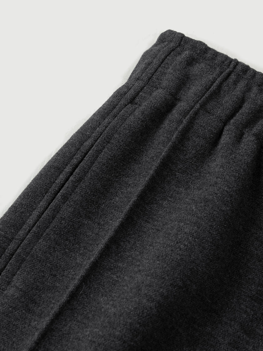 Dark gray sweatpants on a light gray background