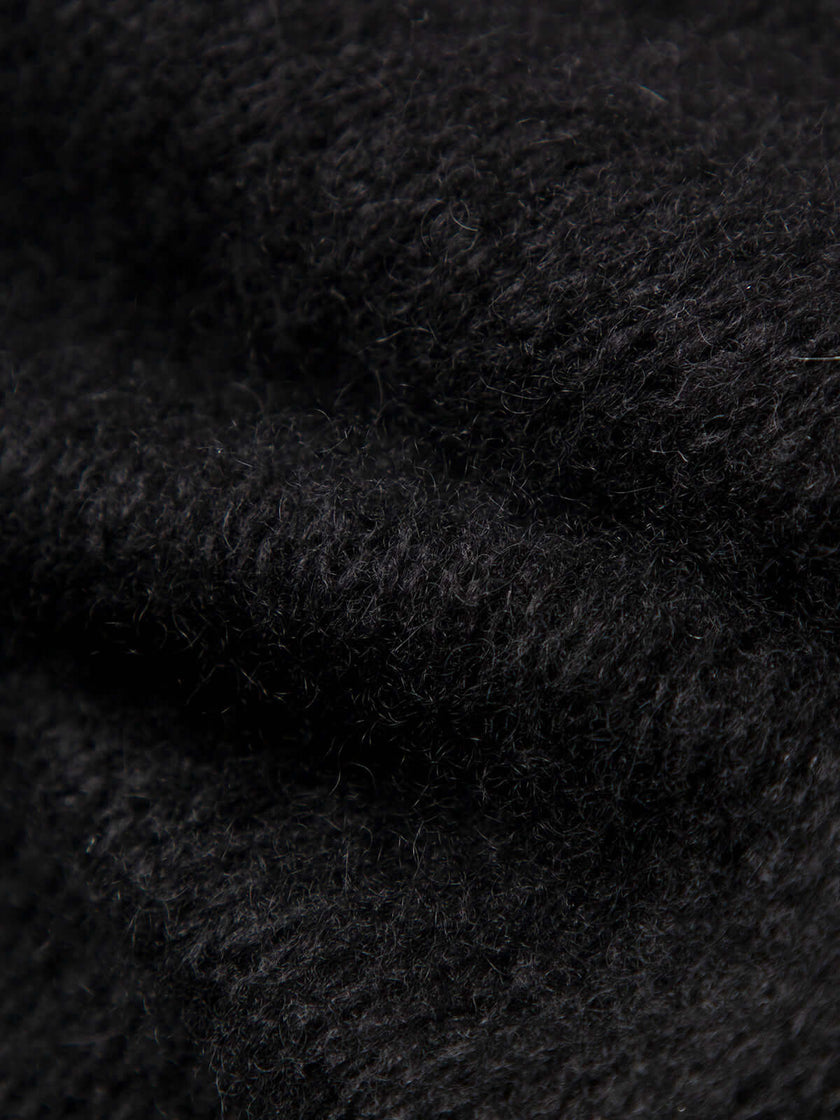 Close-up texture of Cashmere-Silk Relaxed Pullover Sweater showing soft black fabric detail.