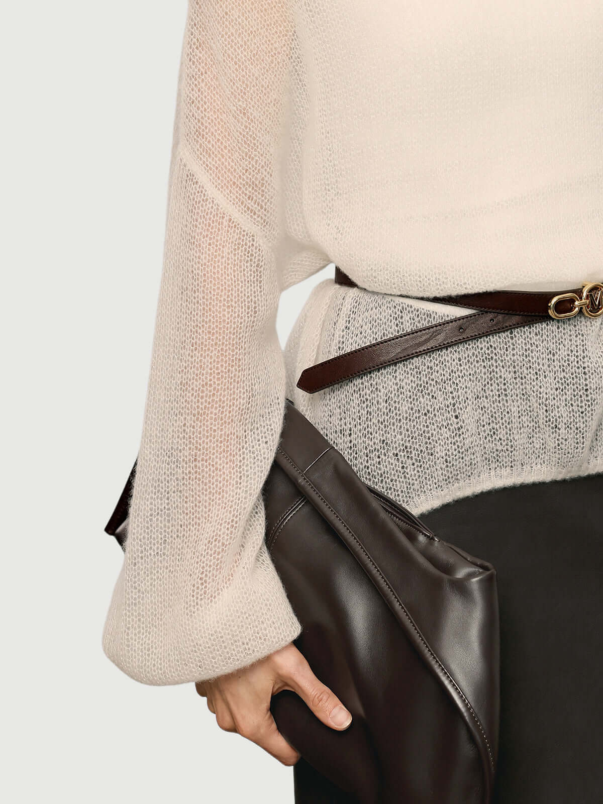 Cashmere-Silk Relaxed Pullover Sweater with a sleek belt and a stylish clutch in a casual outfit.