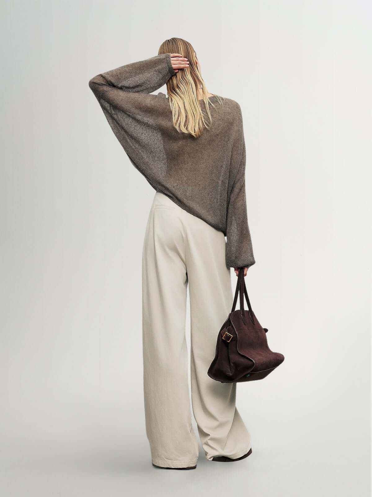 Cashmere-Silk Relaxed Pullover Sweater styled with wide-leg pants and a brown handbag, showcasing a soft, elegant look.