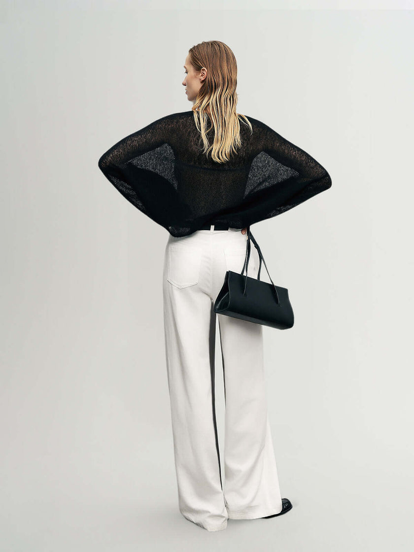 Cashmere-Silk Relaxed Pullover Sweater showcased with wide white trousers and a black handbag.