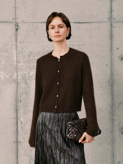 Silk-Cashmere Cardigan worn with a pleated skirt, showcasing its soft texture and versatile style.