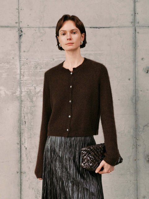 Silk-Cashmere Cardigan worn with a pleated skirt, showcasing its soft texture and versatile style.