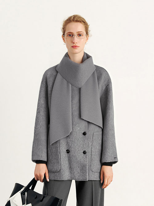 Load image 1 in gallery view. Woman wearing a gray coat with a large scarf on a white background