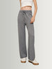 Person wearing gray drawstring pants on a plain background