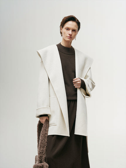 Women's White Oversized Hood Wool Coat, designed with a large hood and soft wool fabric, offering warmth and style for colder seasons.