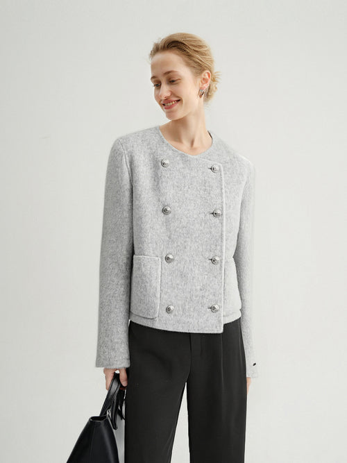 Load image 1 in gallery view. Woman wearing a gray textured jacket with button details on a light gray background