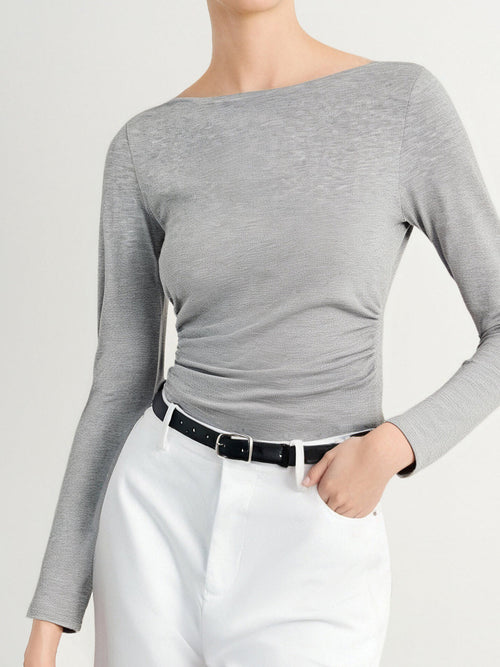 Load image 1 in gallery view. Person wearing a gray long-sleeve top and white pants on a plain background