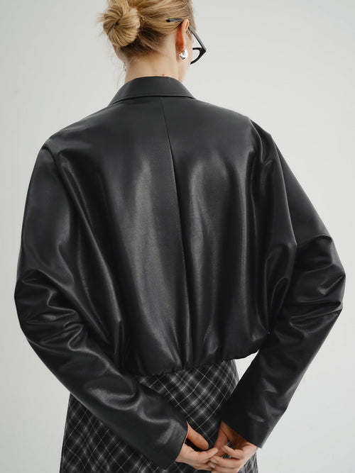 Load image 1 in gallery view. Model wearing a black leather jacket show the back of the outfit