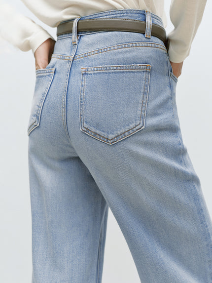 Light blue jeans worn by a person on a plain background