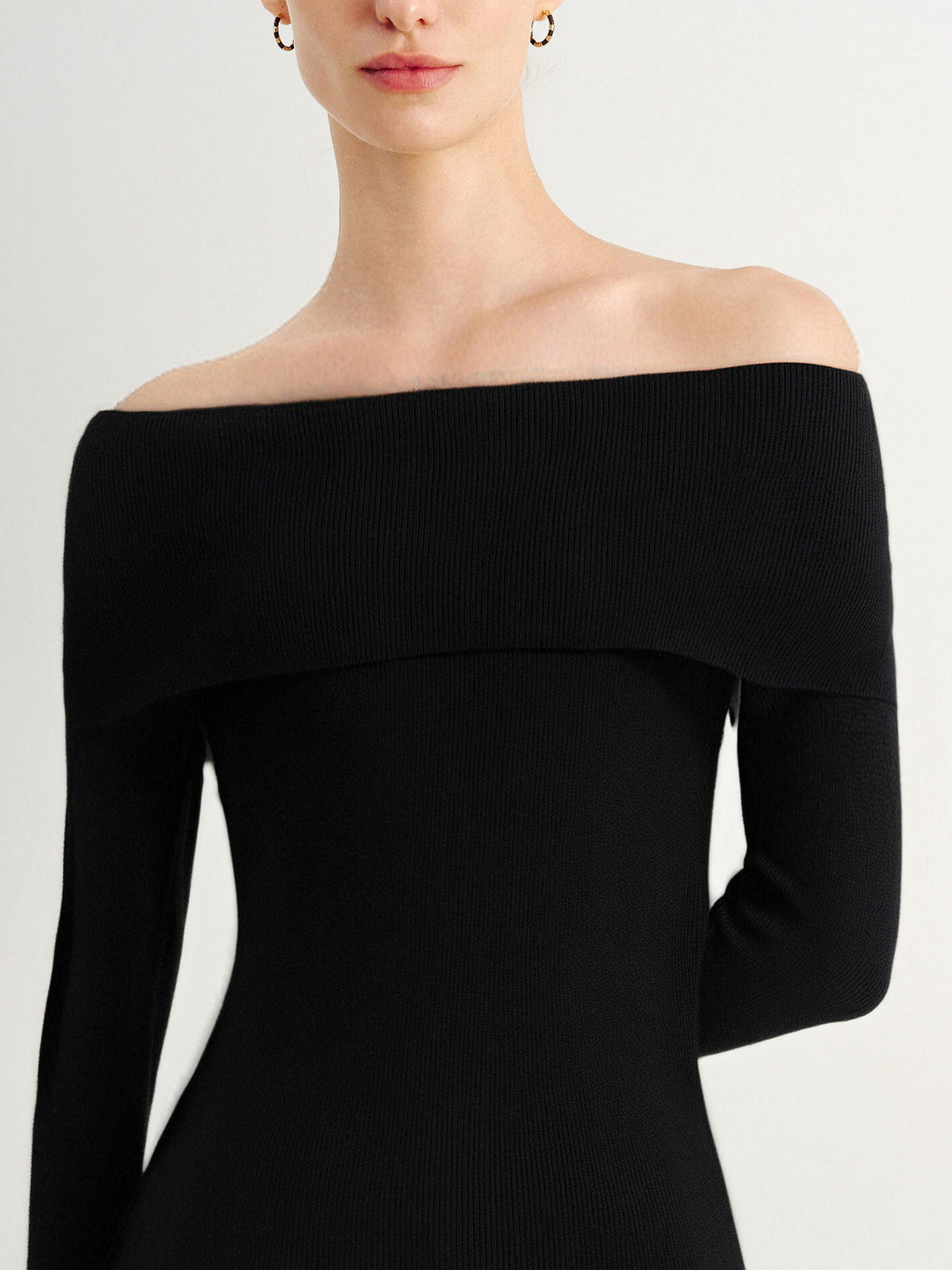 Black off-shoulder dress on a white background