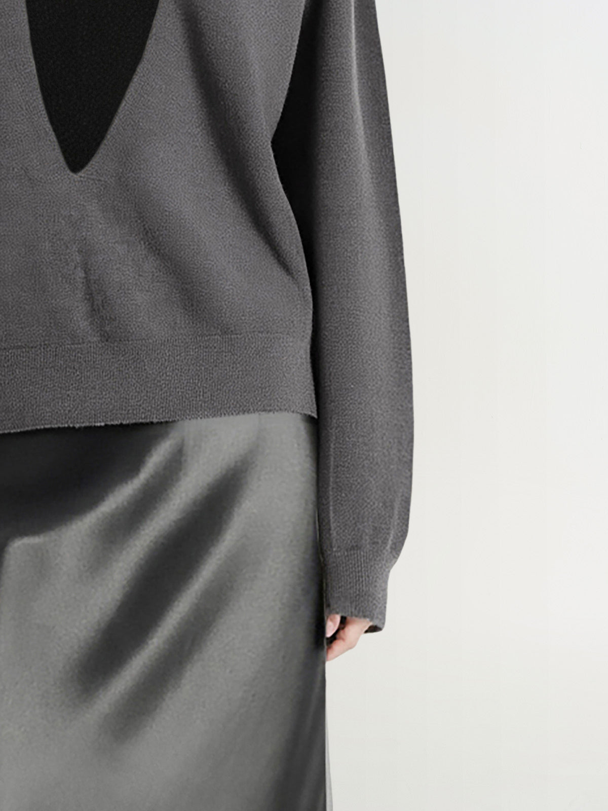 Gray sweater and skirt set on a plain background