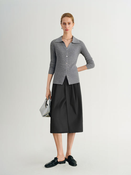 Load image 1 in gallery view. Woman wearing a gray checkered shirt and black skirt on a white background