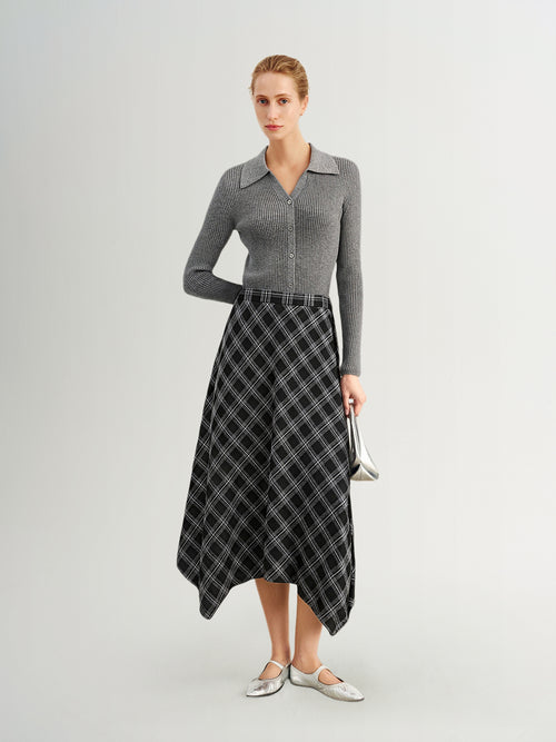 Load image 1 in gallery view. Woman wearing a gray sweater and plaid skirt on a white background