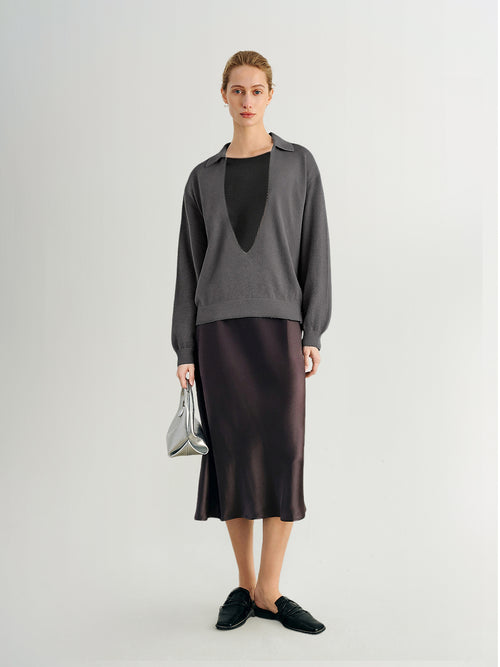 Load image 1 in gallery view. Woman wearing a gray sweater and black skirt on a white background