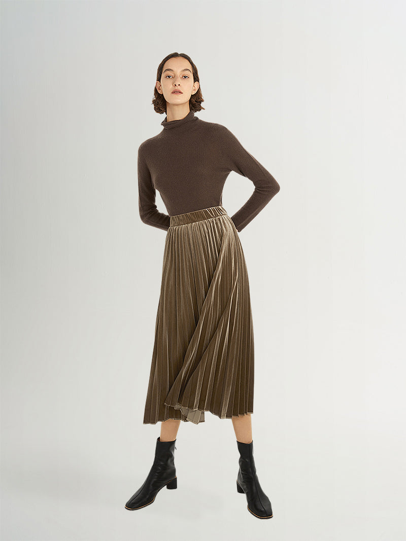 Brown slim fit cashmere sweater paired with a pleated skirt, showcasing a stylish autumn outfit.