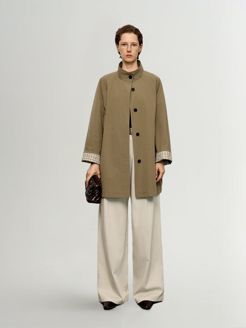 Load image 1 in gallery view. Model wearing a long beige coat with a plain background