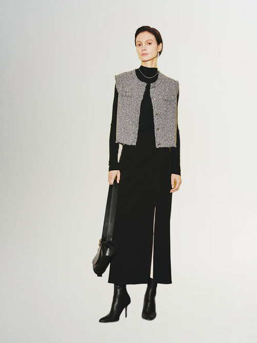 Load image 1 in gallery view. Woman wearing a stylish Tweed Knit Vest over a black dress, showcasing modern fashion.