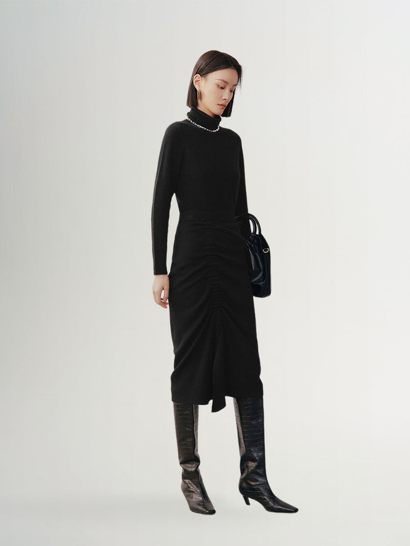 Women wearing a Black High Neck Layering Cashmere Sweater paired with chic black boots, showcasing elegant style.