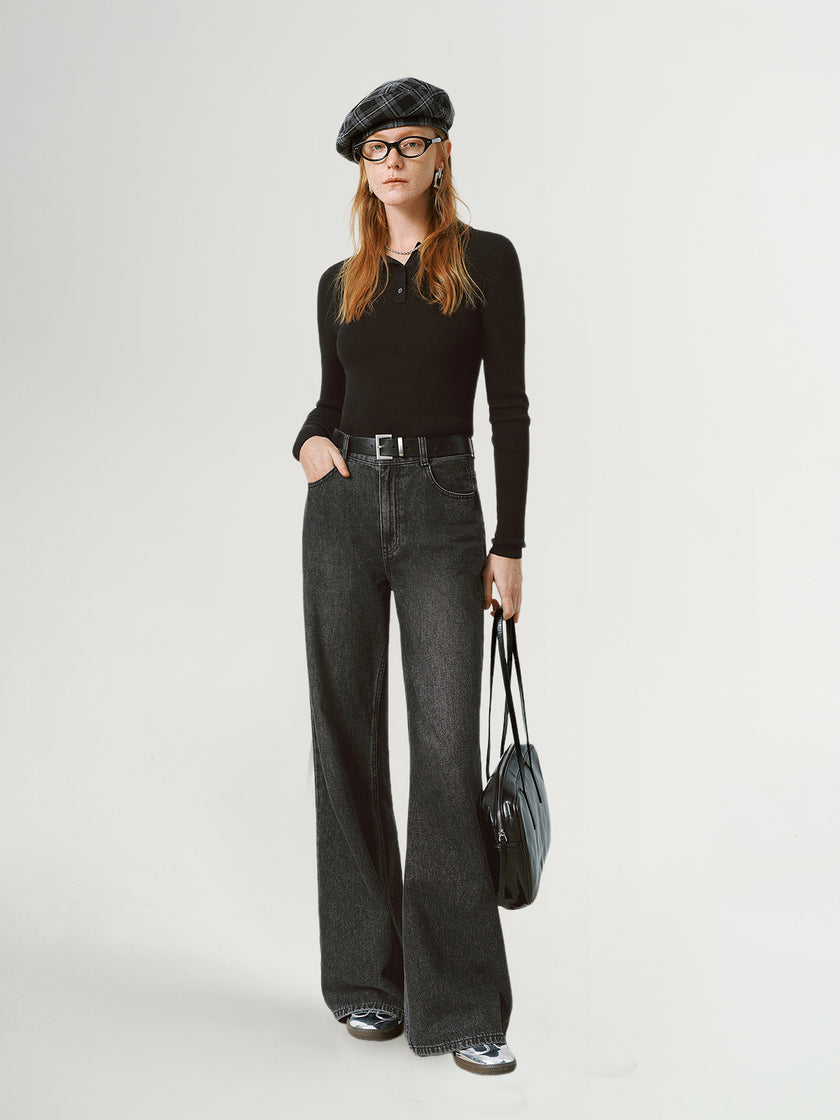 Person wearing a black outfit with a beret and holding a bag on a white background