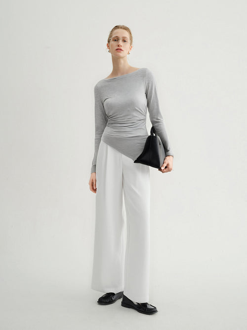 Load image 1 in gallery view. Woman wearing a gray long-sleeve top and white wide-leg pants on a light gray background