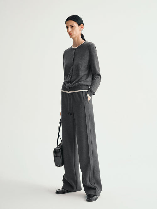 Load image 1 in gallery view. Person wearing a dark gray outfit with wide-leg pants and a black top on a white background