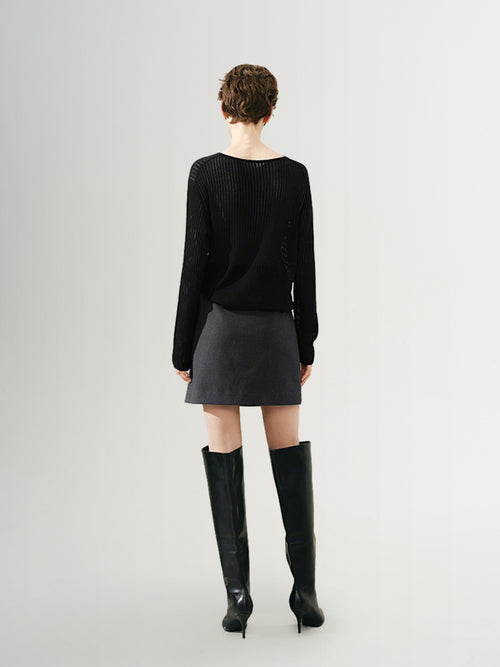 Load image 1 in gallery view. Model wearing a rib knit sweater with a relaxed fit, paired with a short skirt and knee-high boots.
