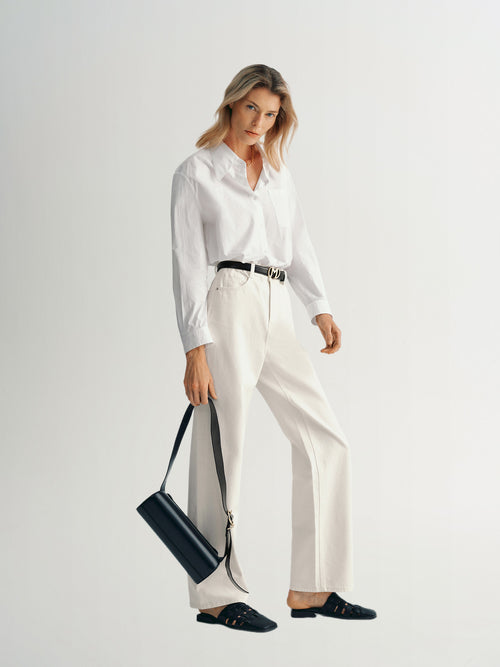 Load image 1 in gallery view. Model wearing a Pure Cotton Shirt with a classic collar, paired with white pants and a black handbag.
