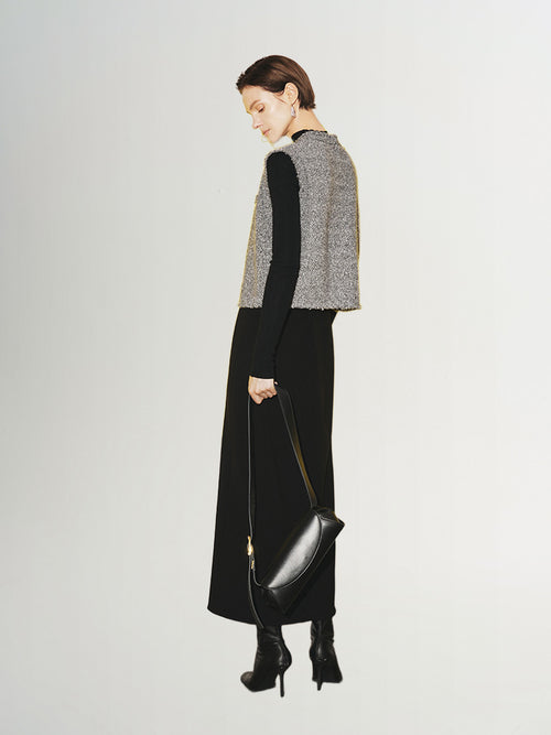Load image 1 in gallery view. Woman wearing a stylish Tweed Knit Vest with a black dress and purse, showcasing a chic and modern look.