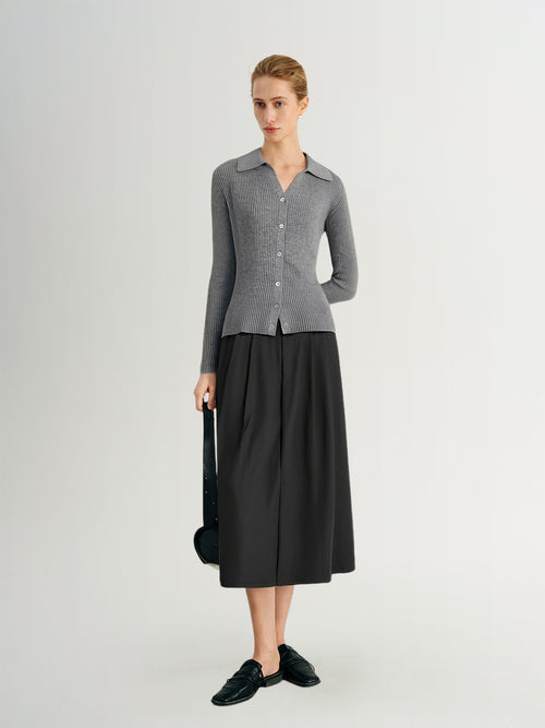 Load image 1 in gallery view. Woman wearing a gray checkered shirt and black skirt on a white background