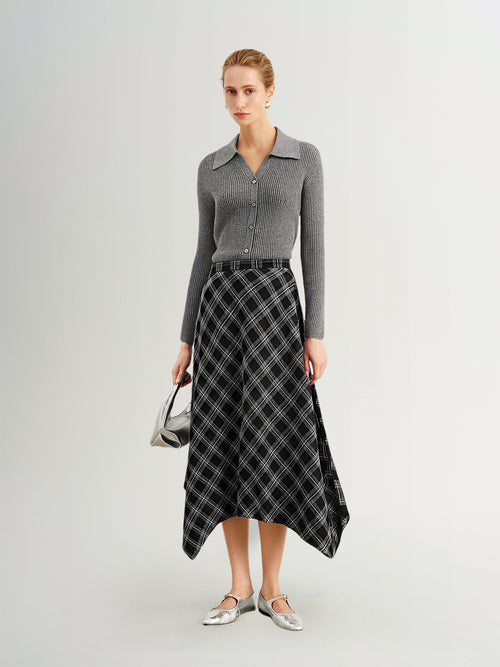 Load image 1 in gallery view. Woman wearing a gray sweater and black plaid skirt on a white background