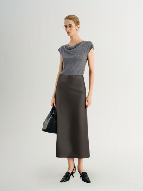Load image 1 in gallery view. Woman wearing a gray top and brown skirt with a black handbag on a white background
