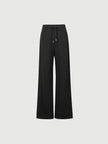Black wide-leg pants on a light gray background