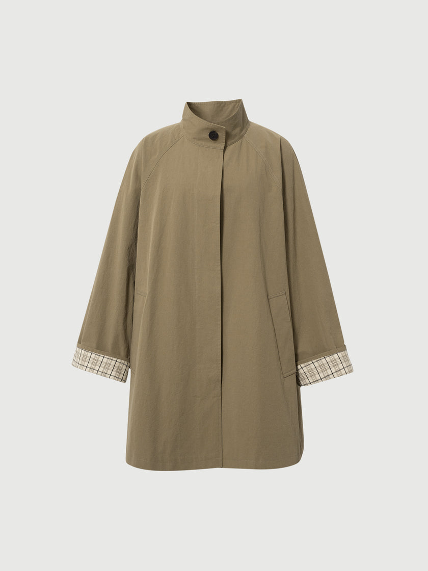 Brown coat with plaid cuffs on a light gray background