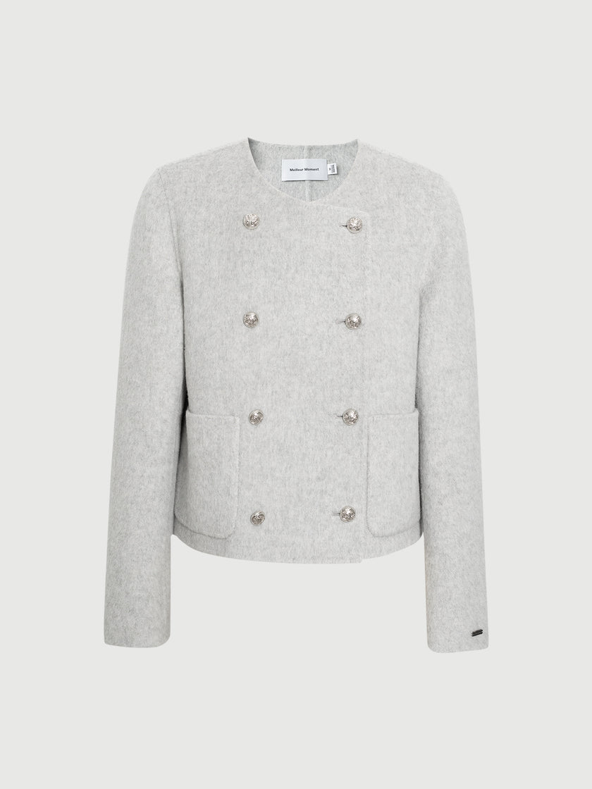 Light gray blazer with button details on a white background