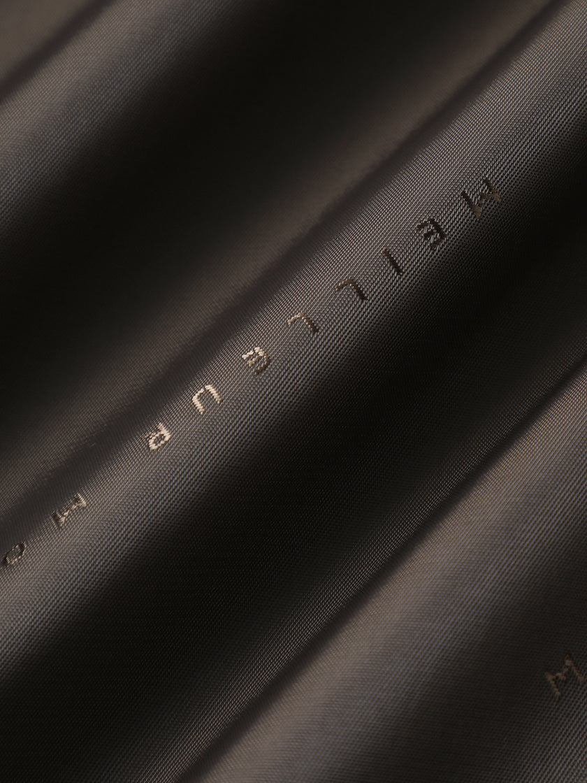 Close-up of black fabric with 'MEILEN' branding.