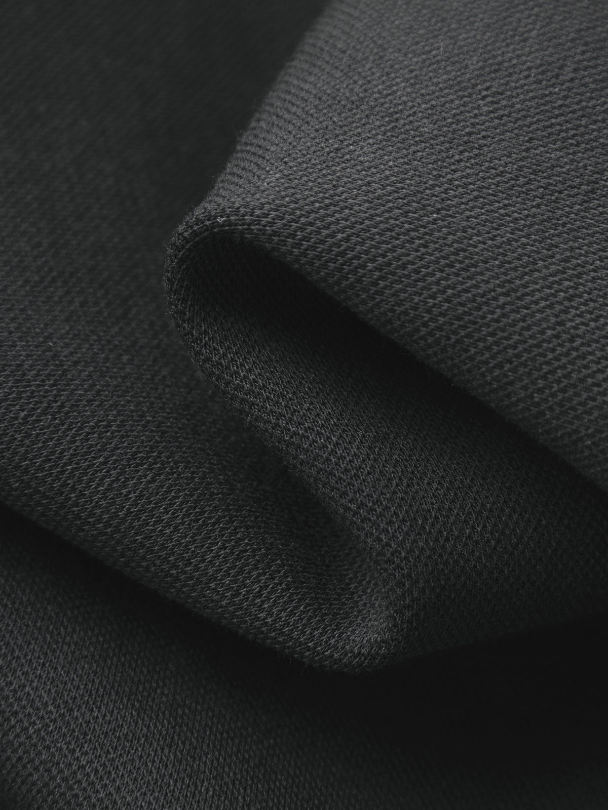 Close-up of dark gray fabric with a textured surface