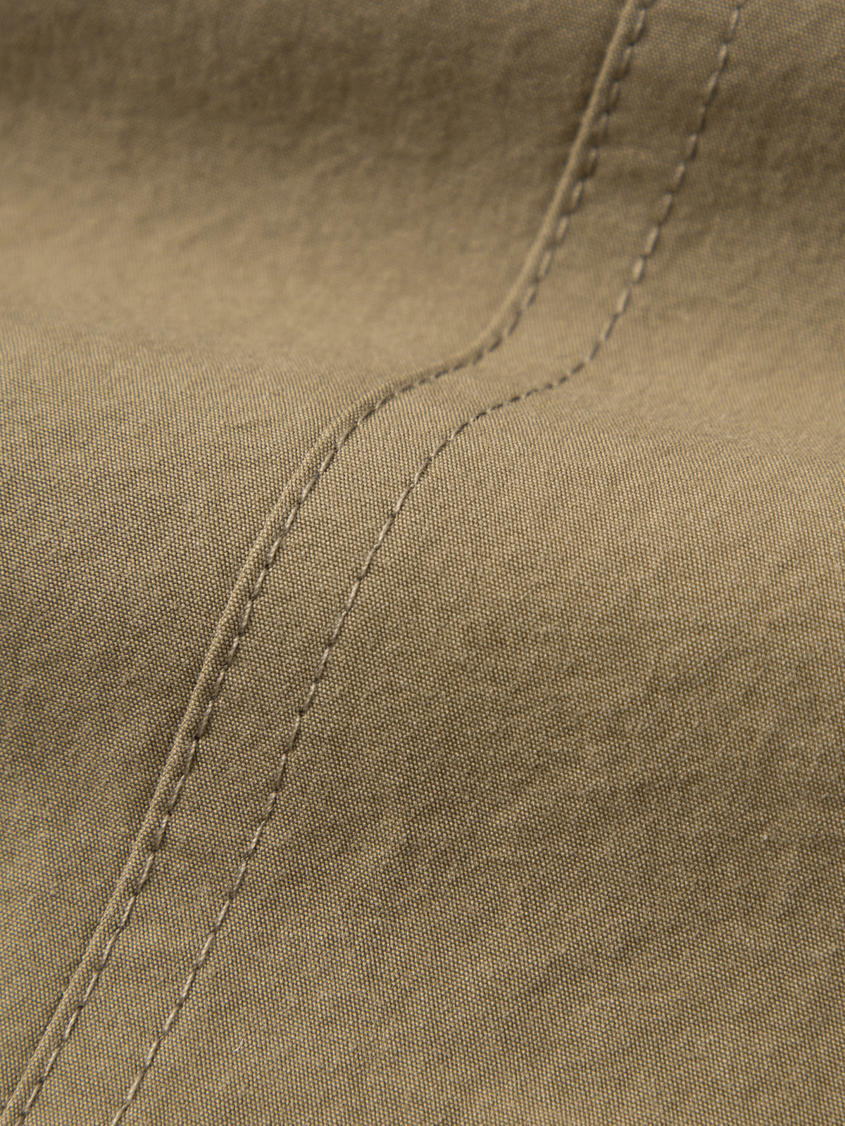 Close-up of brown fabric with stitching detail