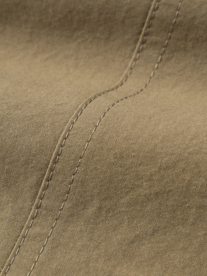 Close-up of brown fabric with stitching detail