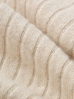 Close-up of beige knitted fabric texture