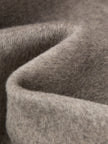 Close-up of textured brown fabric with a focus on texture and color.