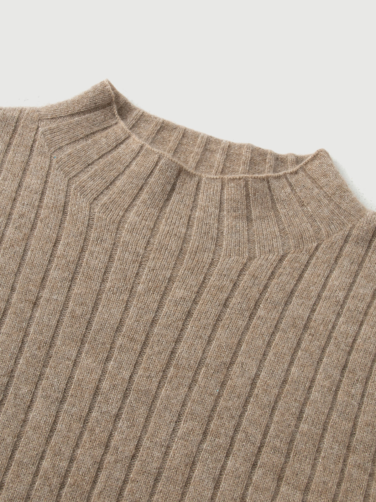 Close-up of a brown ribbed knit sweater on a light gray background