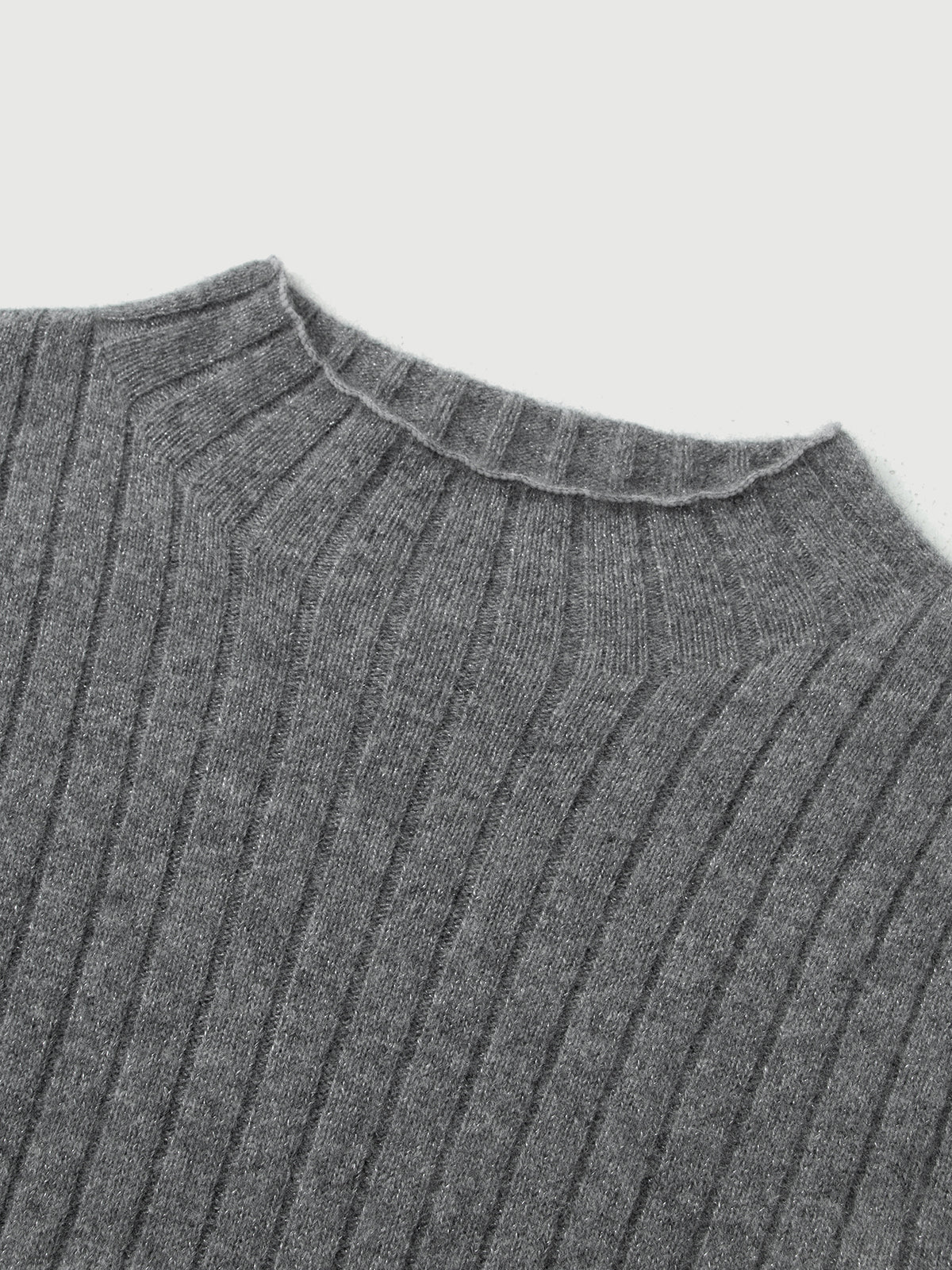 Close-up of a ribbed gray sweater collar on a light gray background